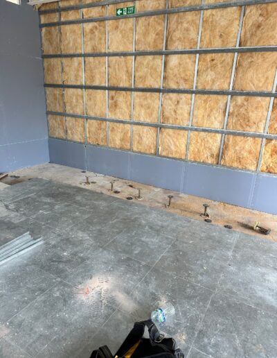 Acoustic mineral wool insulation fitted into a metal stud wall cavity